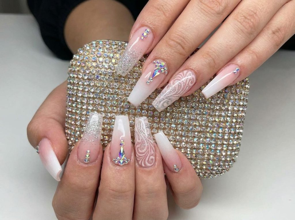 “long acrylic nails with rhinestones and glitter, glamorous nail art, high detail”