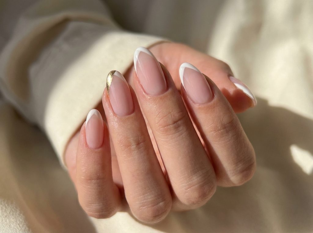 “french tip nails modern twist, soft pink base, elegant nails, close up”
