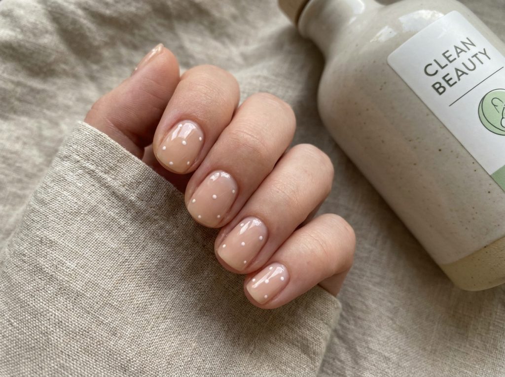 “minimalist nails nude base white dots, clean beauty aesthetic”